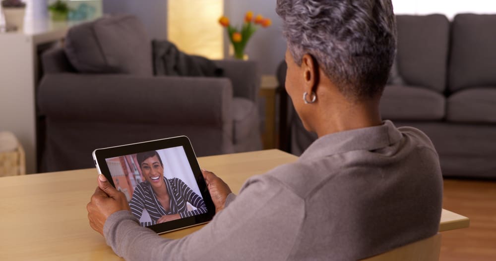 Woman chats with someone via technology for social distance connection